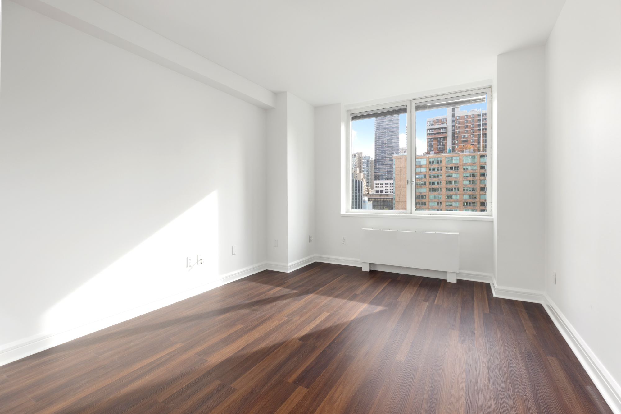 100 Riverside Boulevard, Unit 9B Manhattan, NY 10069 - Photo 6 of 8 an empty room with wooden floor and windows