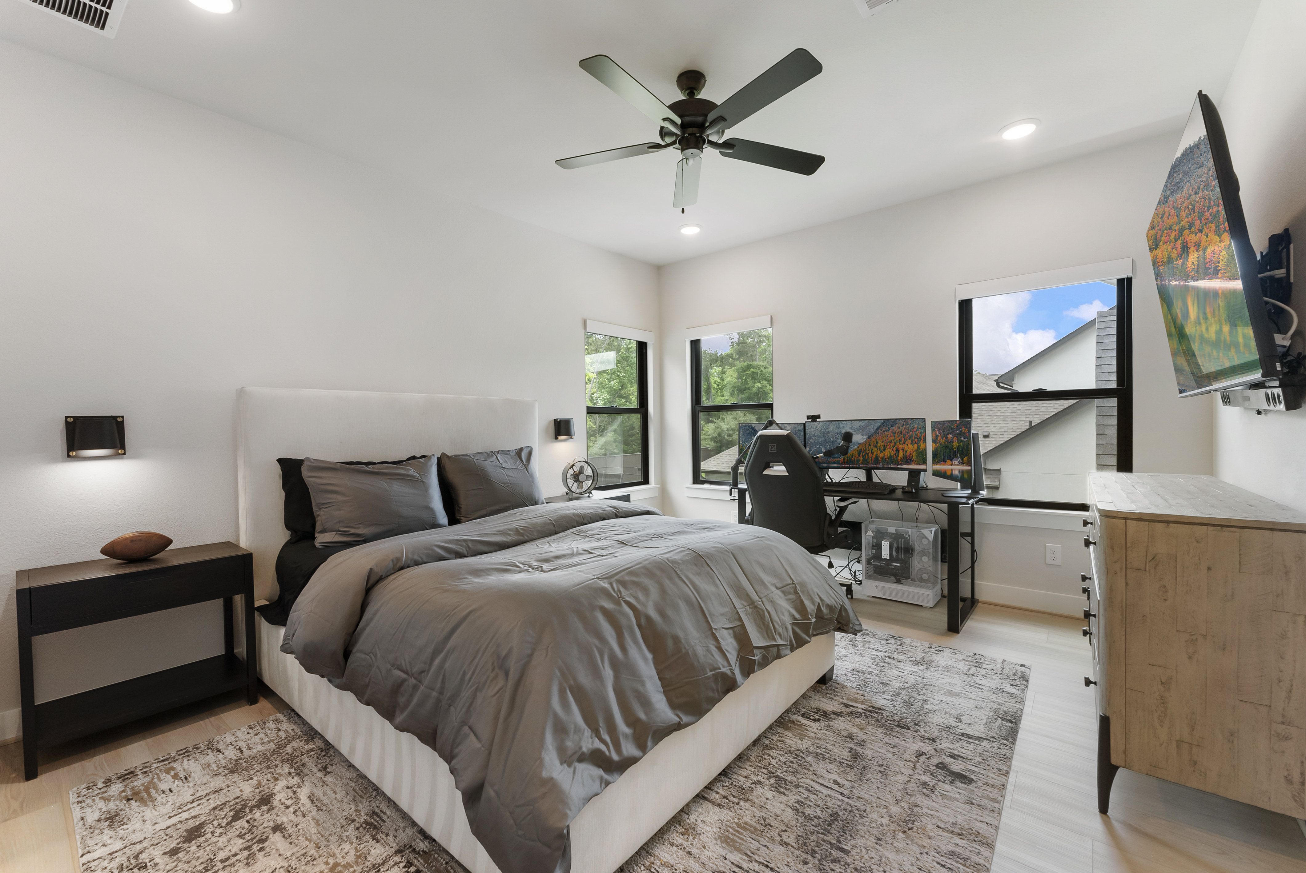 2118 Bennet Court Conroe, TX 77384 - Photo 56 of 70 a spacious bedroom with a bed and a flat screen tv