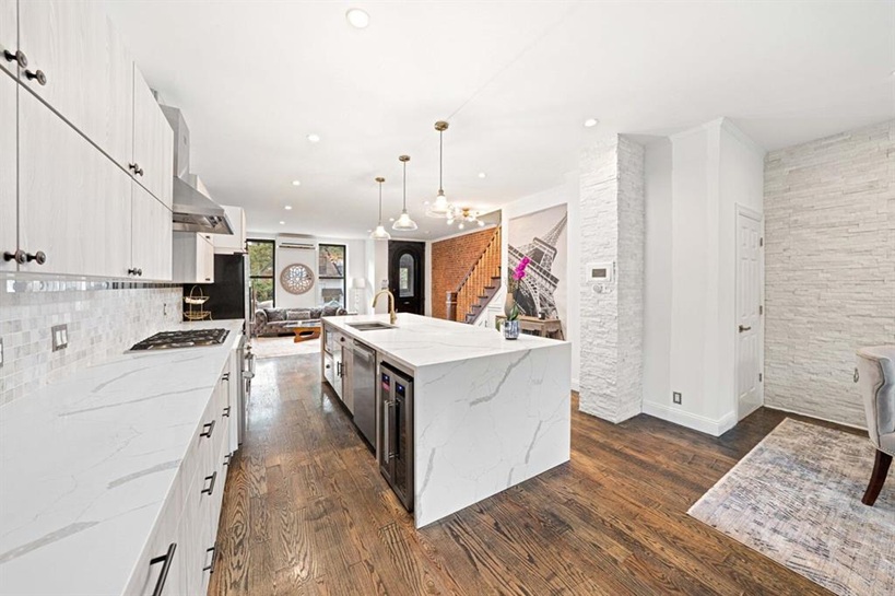 308 Clifton Place Brooklyn, NY 11216 - Photo 6 of 41 a kitchen with stainless steel appliances kitchen island granite countertop a stove and a refrigerator