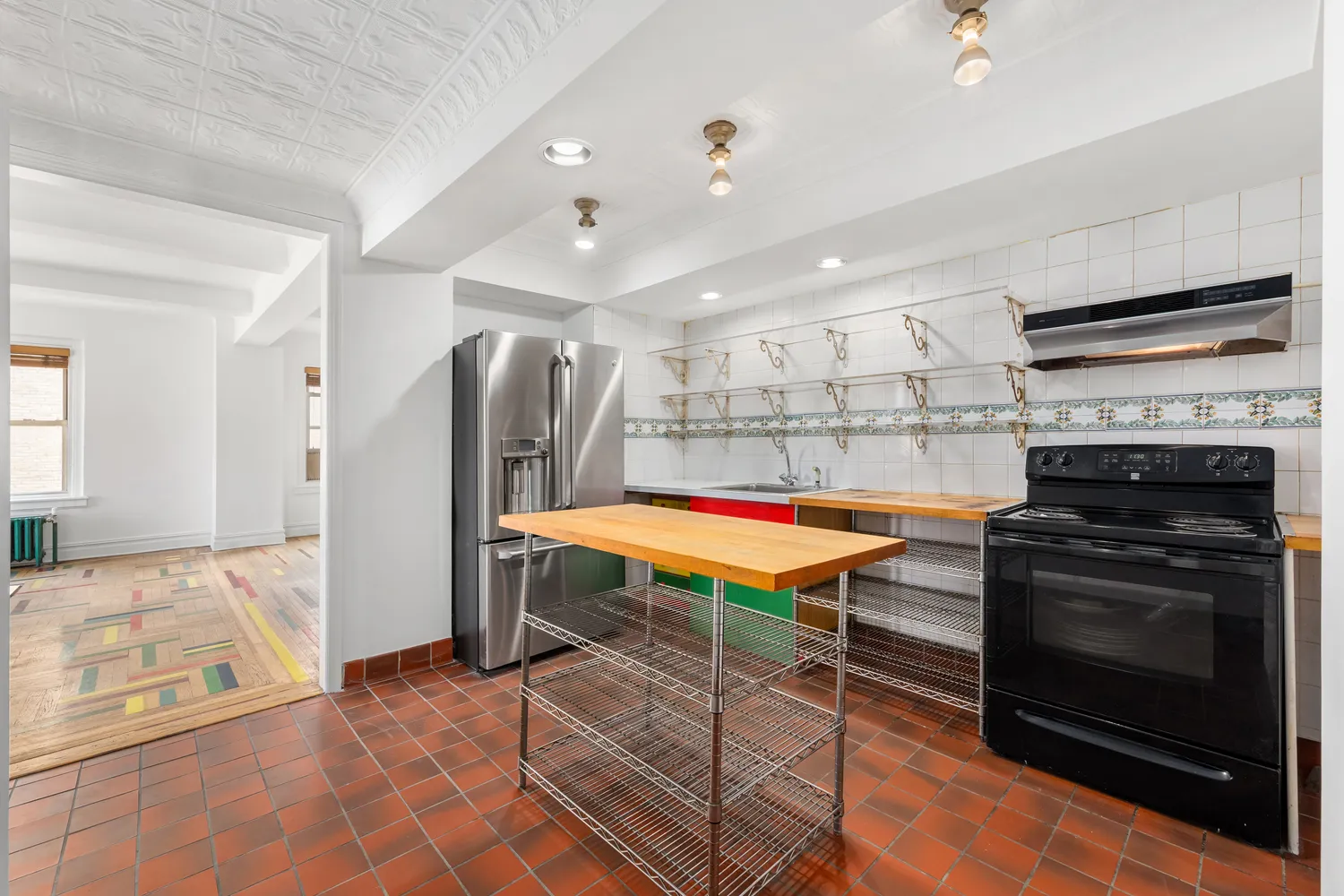 a kitchen with stainless steel appliances kitchen island granite countertop a refrigerator and a stove top oven