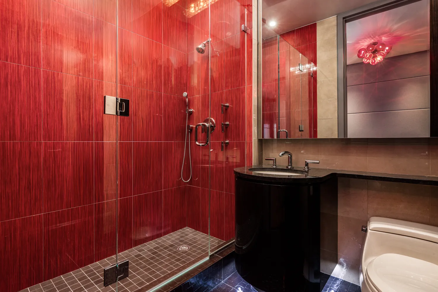 a bathroom with a sink toilet and shower