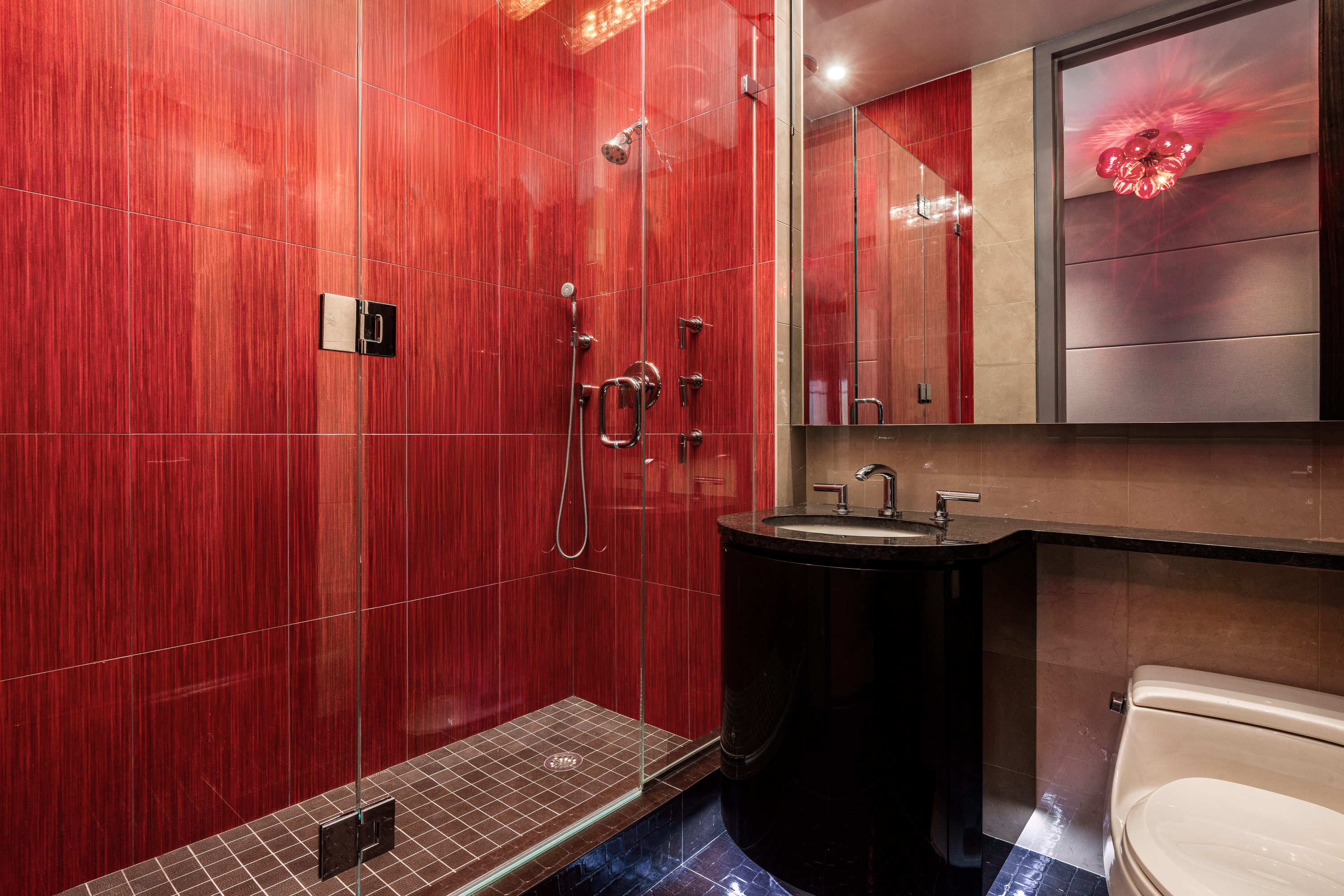 845 United Nations Plaza, Unit 86B Manhattan, NY 10017 - Photo 12 of 16 a bathroom with a sink toilet and shower