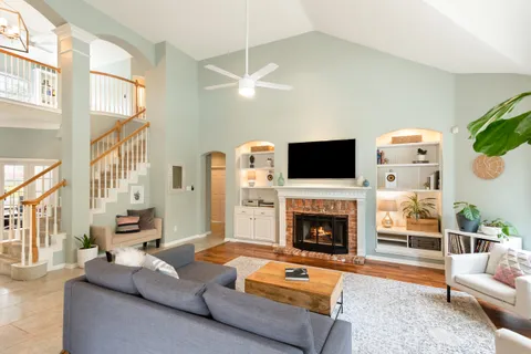 a living room with fireplace furniture and a flat screen tv