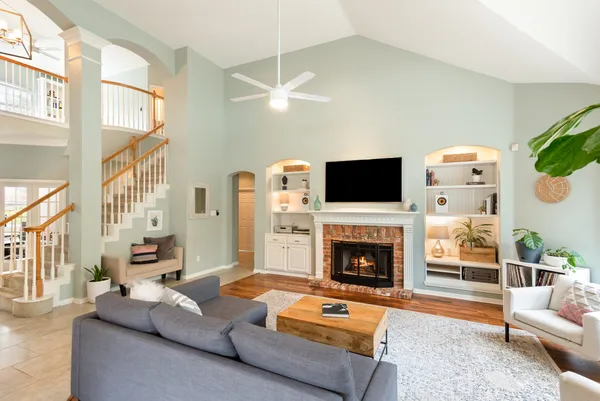 a living room with fireplace furniture and a flat screen tv