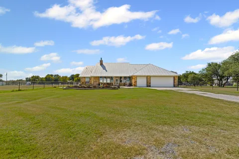 an aerial view of a house with a lake view
