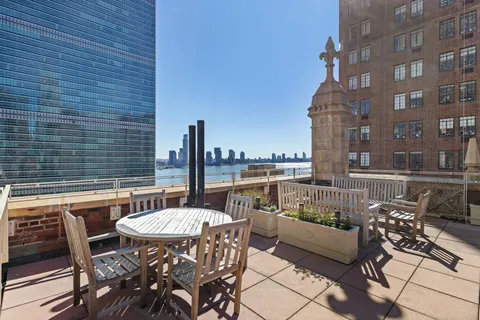a table and chairs sitting in front of a building