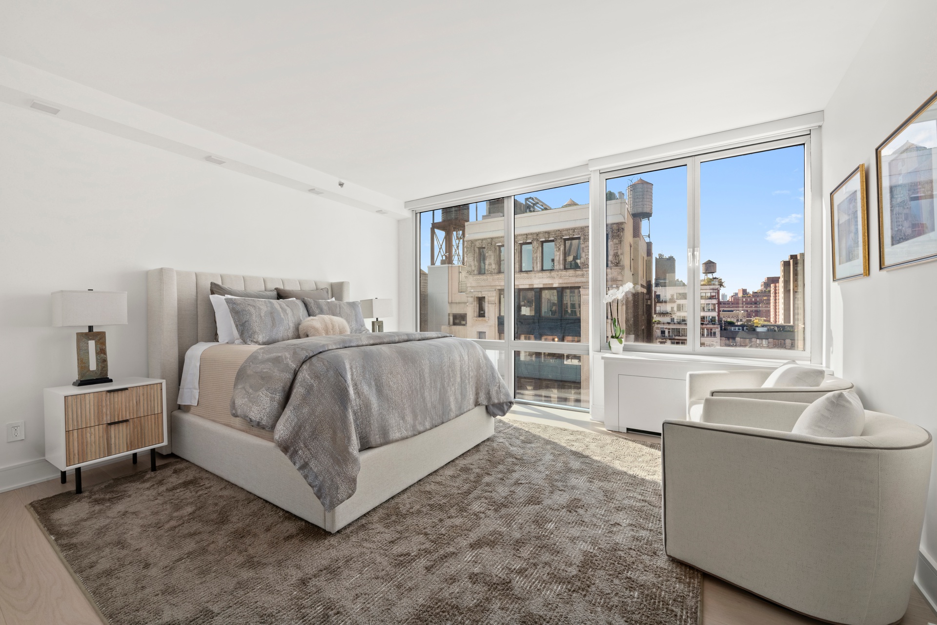 151 West 17th Street, Unit PHF-FURN Manhattan, NY 10011 - Photo 11 of 19 a bedroom with a large bed and a couch