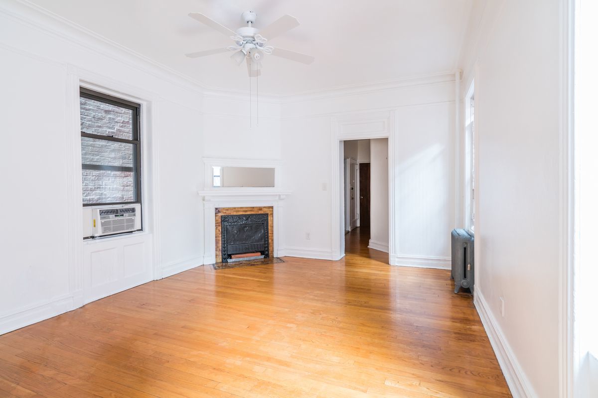 212 West 14th Street, Unit 3B Manhattan, NY 10011 - Photo 2 of 6 a view of an empty room with a window and fireplace