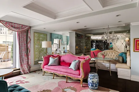 a living room with furniture a rug and a window