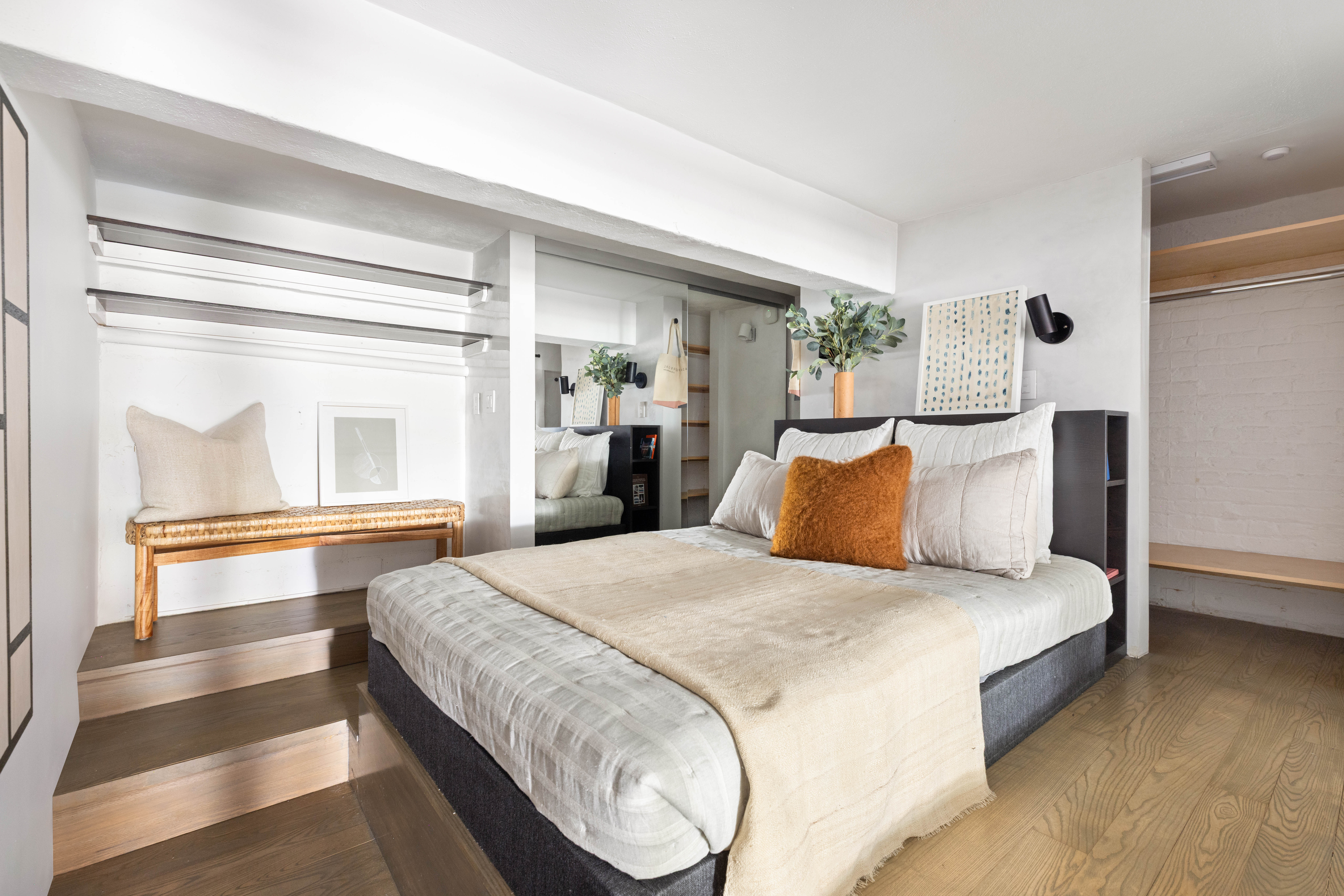 165 Perry Street, Unit 1D Manhattan, NY 10014 - Photo 8 of 13 a bedroom with a large bed and wooden floor