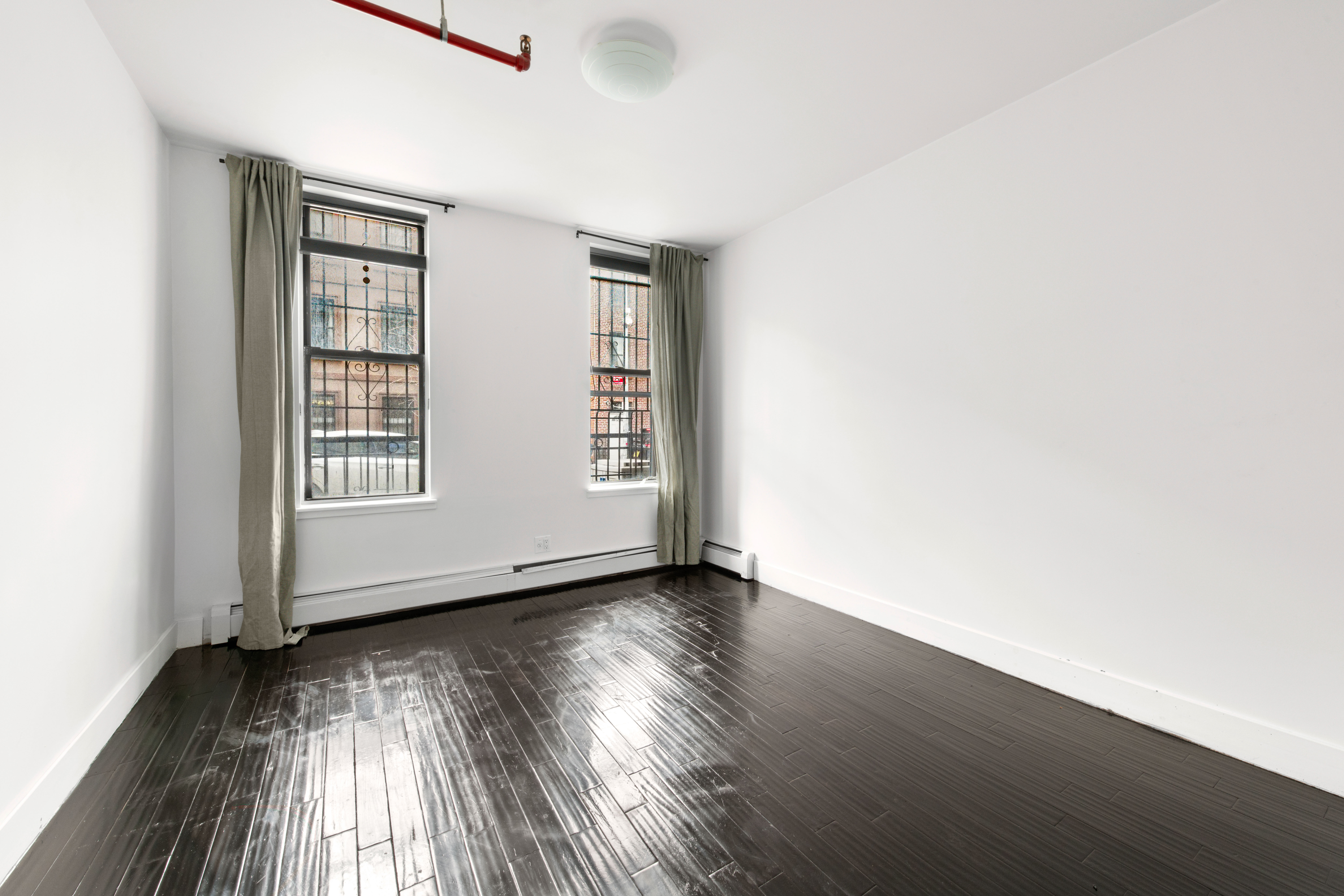 155 A 9th Street, Unit 1 Brooklyn, NY 11231 - Photo 5 of 15 an empty room with wooden floor and windows