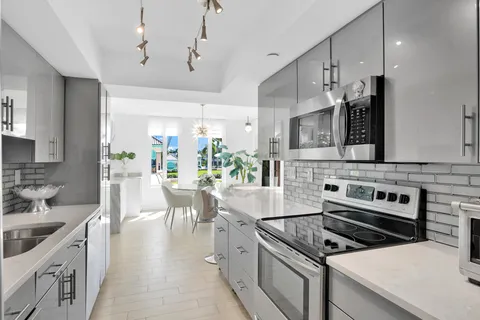 a kitchen with a stove a sink and a refrigerator