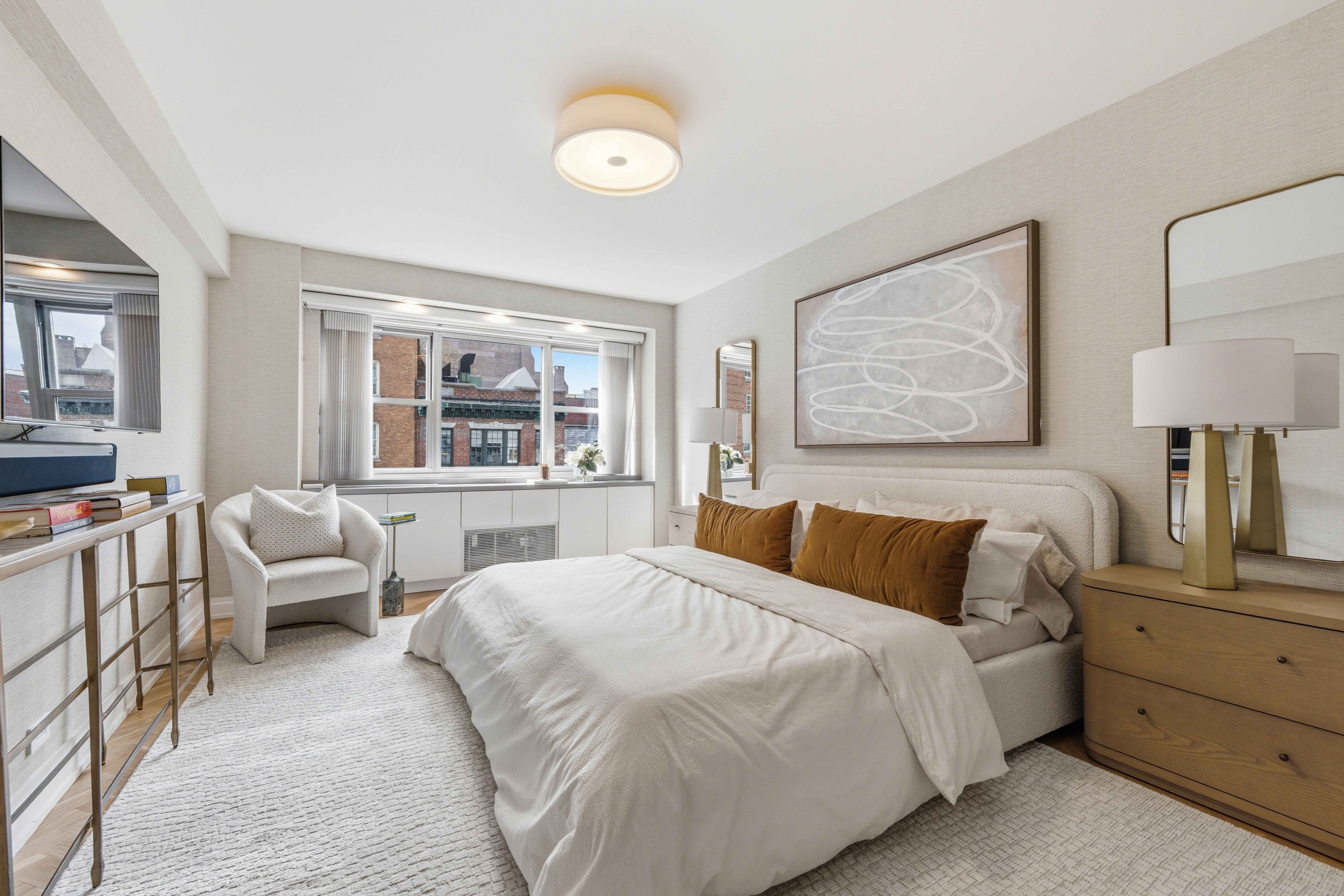 40 East 78th Street, Unit 5E Manhattan, NY 10075 - Photo 10 of 23 a bedroom with a large bed and a couch