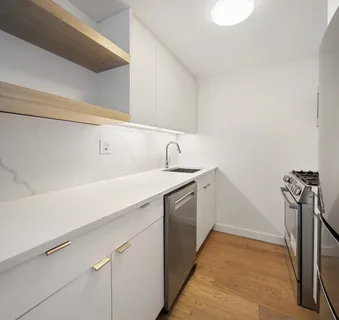 a kitchen with a sink and stainless steel appliances