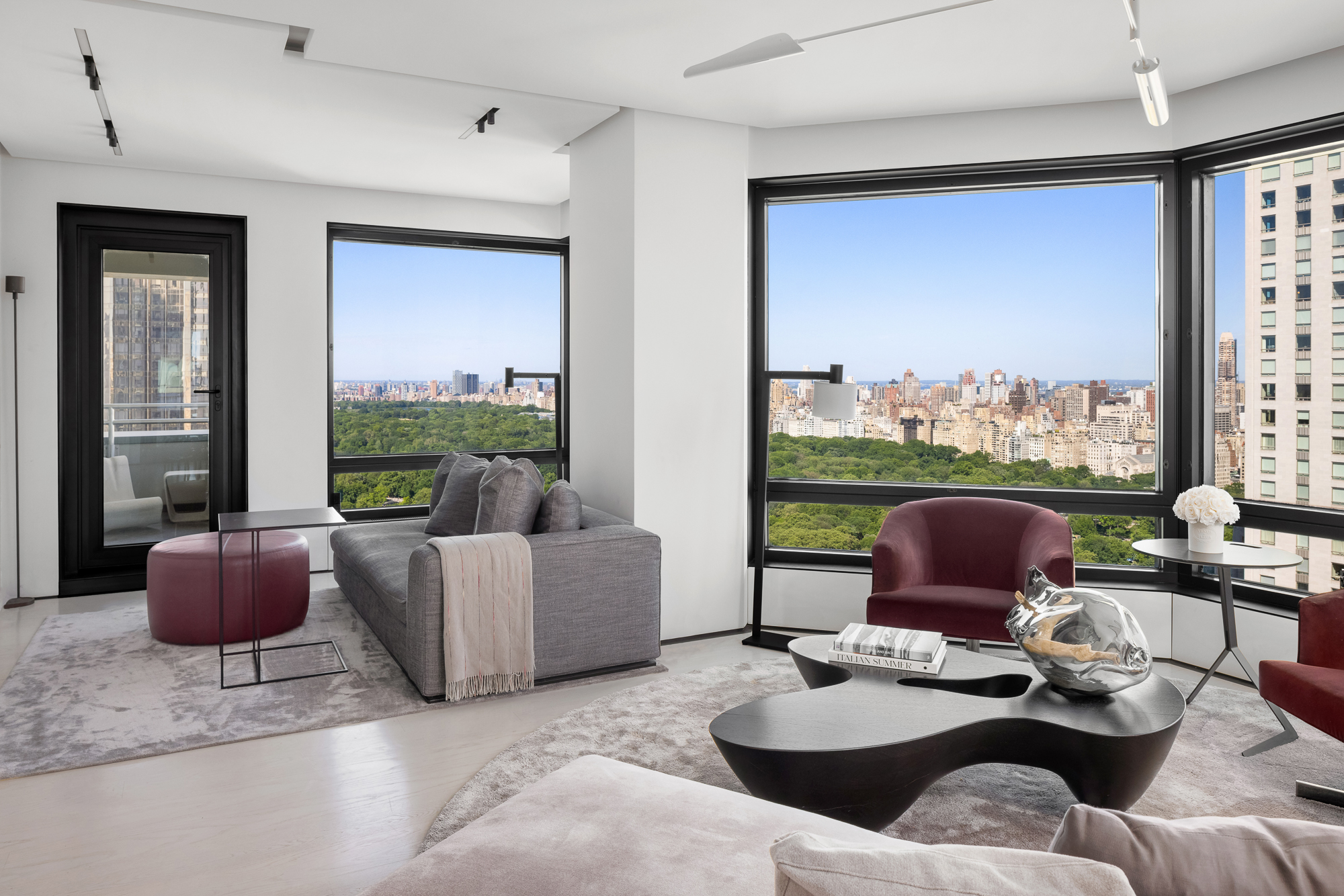 301 West 57th Street, Unit 36C Manhattan, NY 10019 - Photo 4 of 27 a living room with furniture and a floor to ceiling window