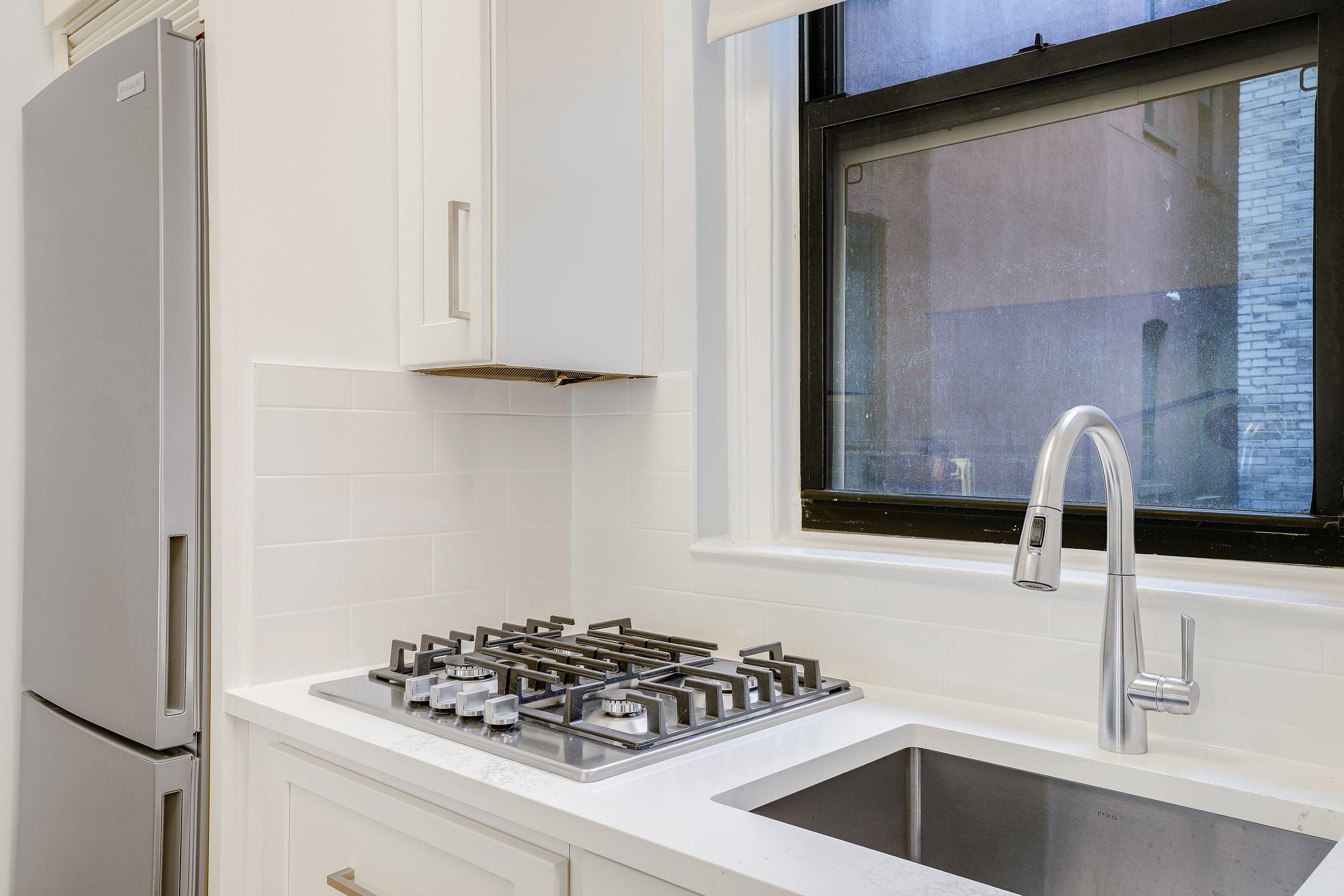 129 West 89th Street, Unit 36 Manhattan, NY 10024 - Photo 8 of 14 a kitchen with a sink and cabinets