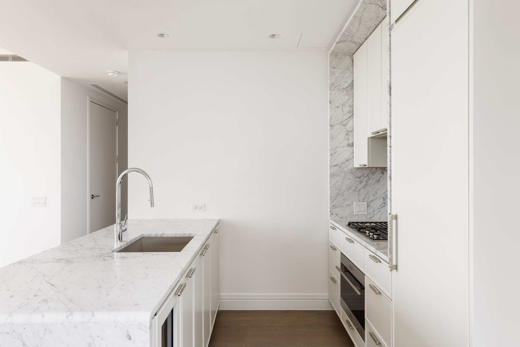 430 East 58th Street, Unit 39A Manhattan, NY 10022 - Photo 5 of 15 a kitchen with a sink and a stove top oven