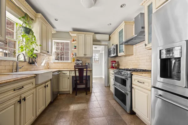 a kitchen with stainless steel appliances granite countertop a stove and a refrigerator