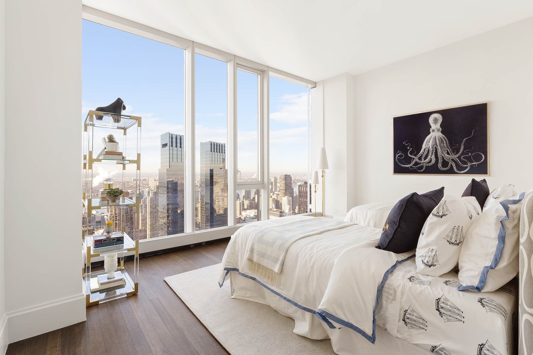217 West 57th Street, Unit 60W Manhattan, NY 10019 - Photo 11 of 27 a bedroom with a bed and glass walk in closet
