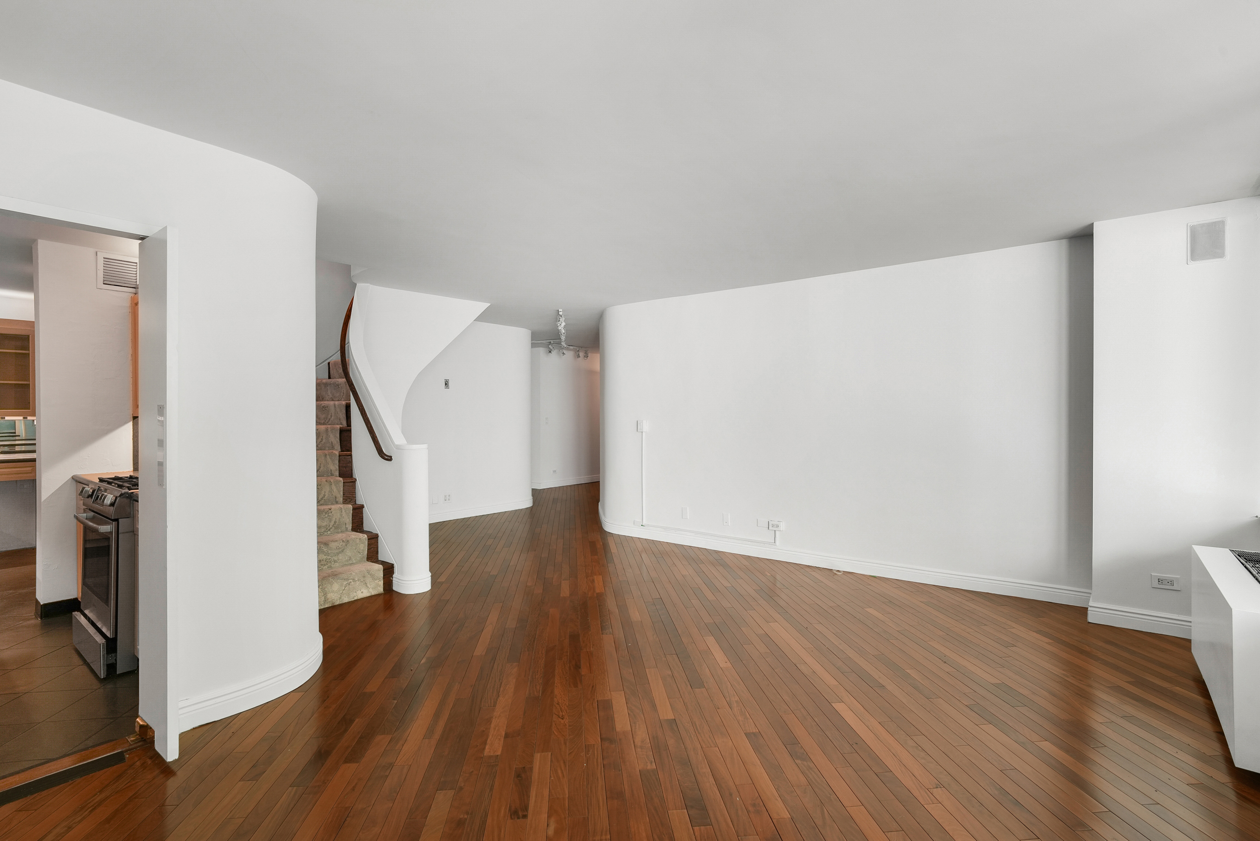 309 East 49th Street, Unit 2B3B Manhattan, NY 10017 - Photo 3 of 16 a view of a room with wooden floor and stairs