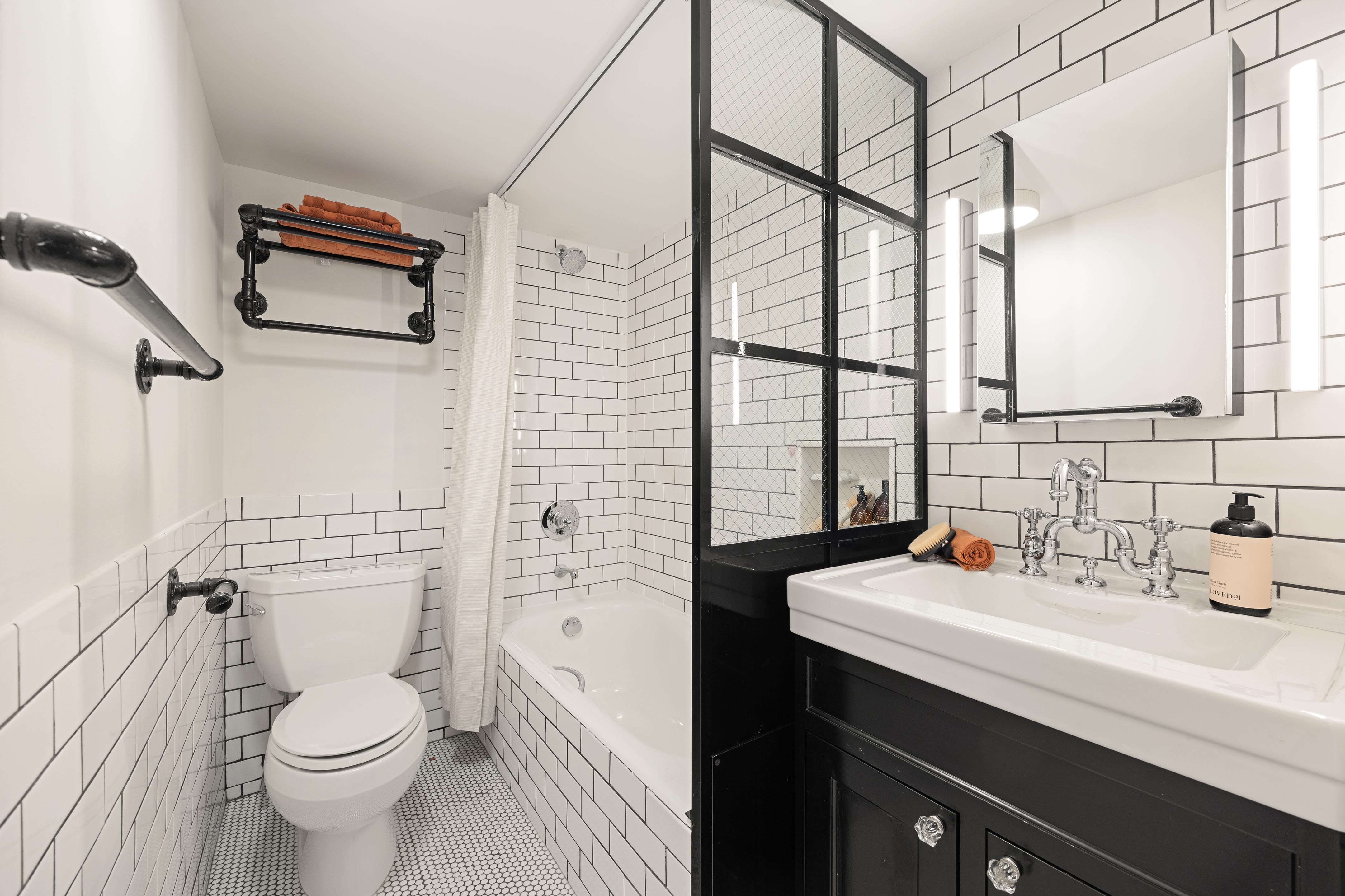 300 East 4th Street, Unit 2A Manhattan, NY 10009 - Photo 6 of 15 a bathroom with a sink a toilet and shower