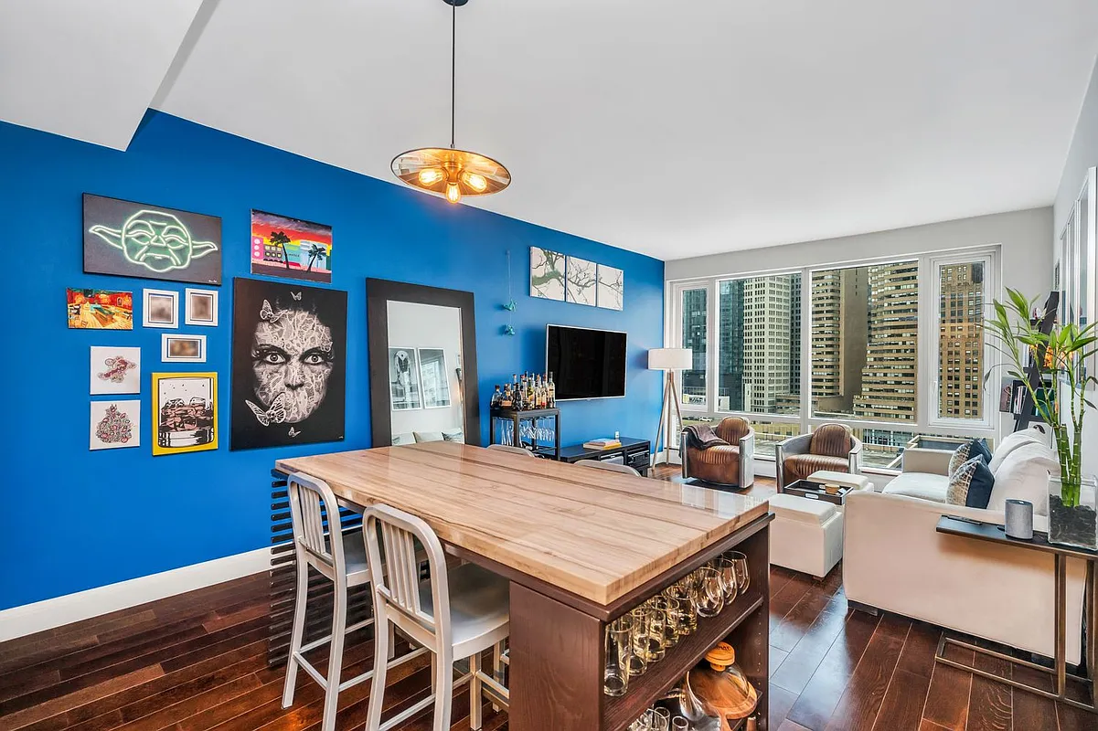 70 Little West Street, Unit 15A Manhattan, NY 10004 - Photo 3 of 19 a view of a dining room with furniture window and wooden floor