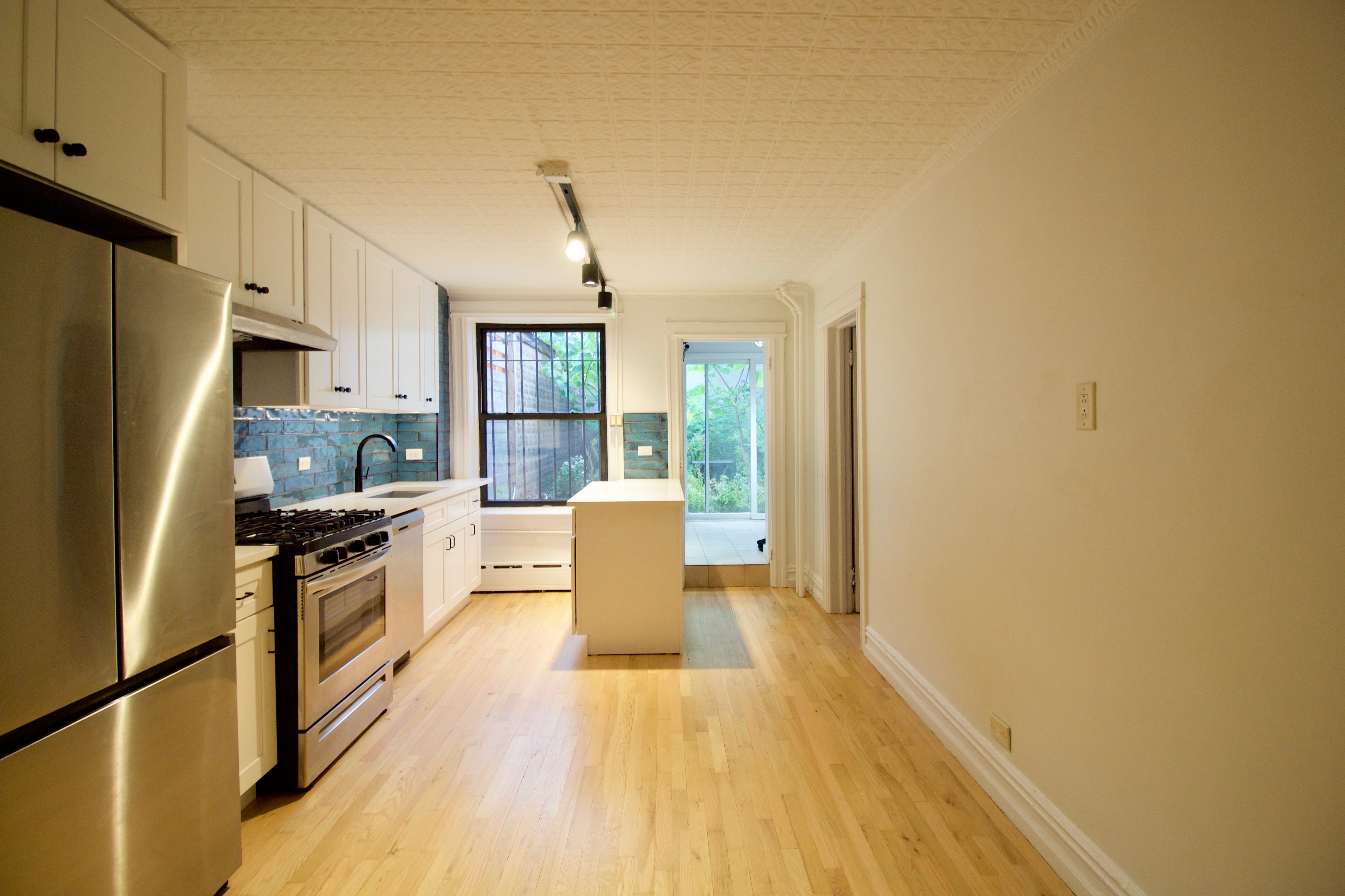 403 Caton Avenue, Unit 1 Brooklyn, NY 11218 - Photo 23 of 37 a kitchen with stainless steel appliances a refrigerator and a stove