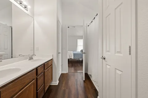 a bathroom with a sink a toilet and a large mirror