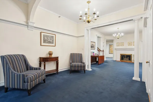 a view of a workspace with furniture window and wooden floor