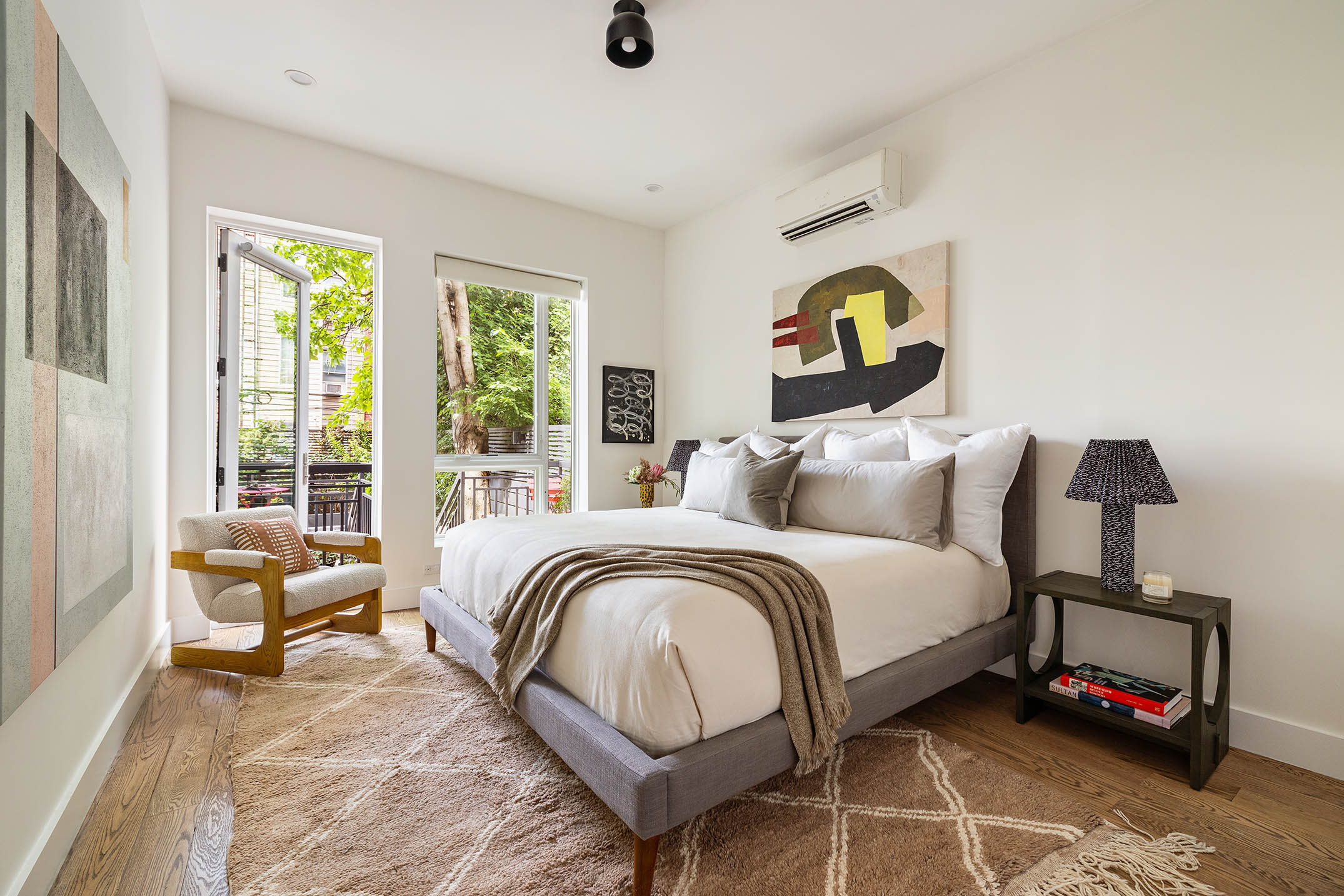 1025 Lorimer Street, Unit PARLOR Brooklyn, NY 11222 - Photo 11 of 21 a bedroom with a bed a couch and a window