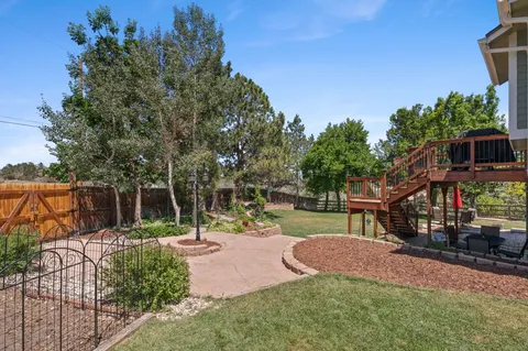 a view of backyard of house with green space and seating