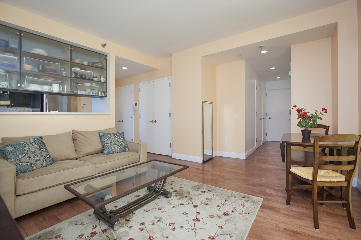 249 East 118th Street, Unit 7A Manhattan, NY 10035 - Photo 2 of 9 a living room with furniture and wooden floor