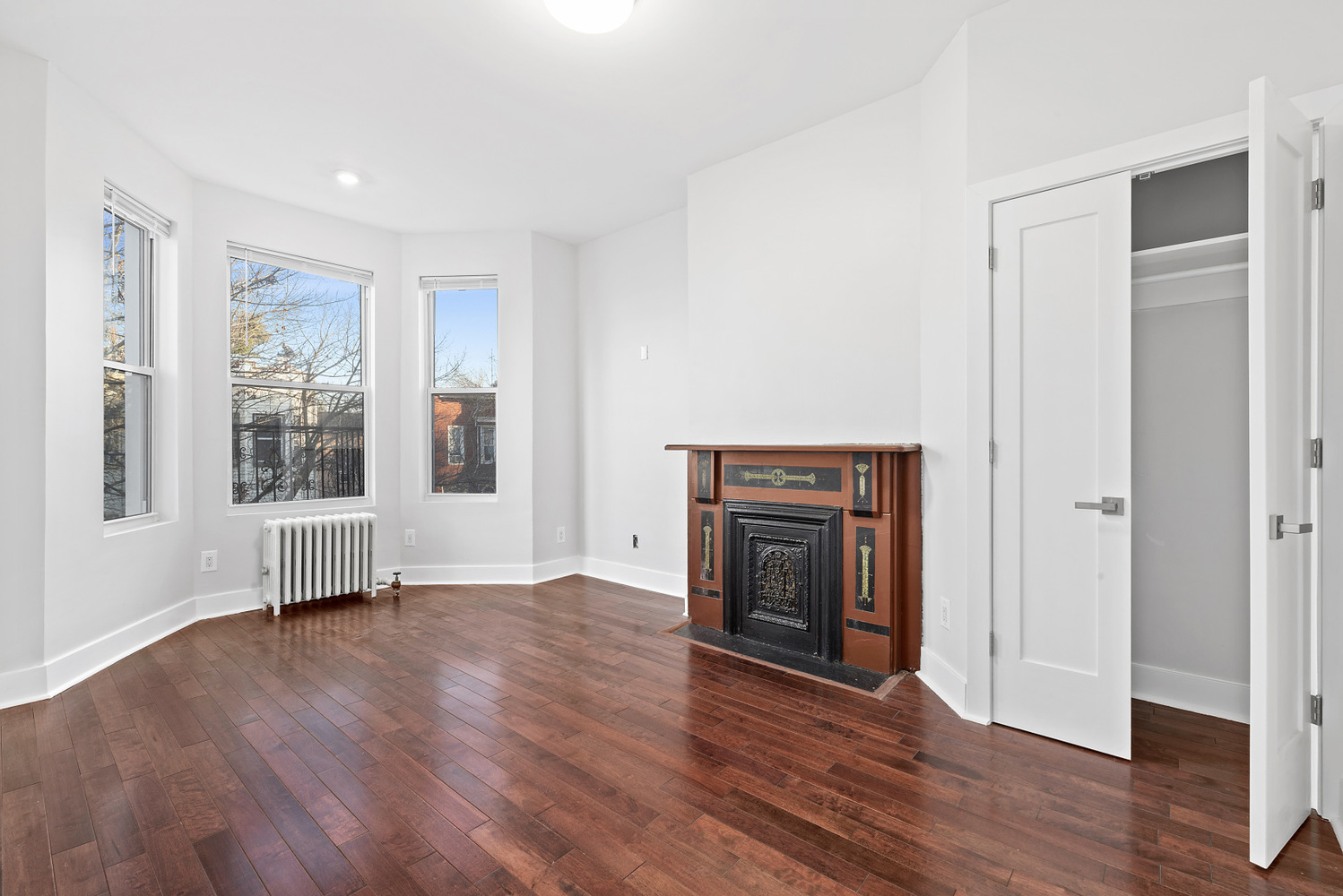 1275 Jefferson Avenue, Unit 3 Brooklyn, NY 11221 - Photo 2 of 6 a view of an empty room with wooden floor and a window