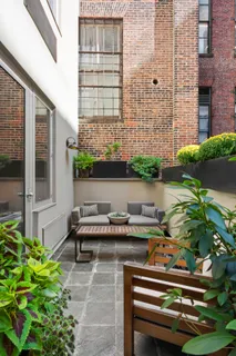 a table and chairs sitting in front of a building
