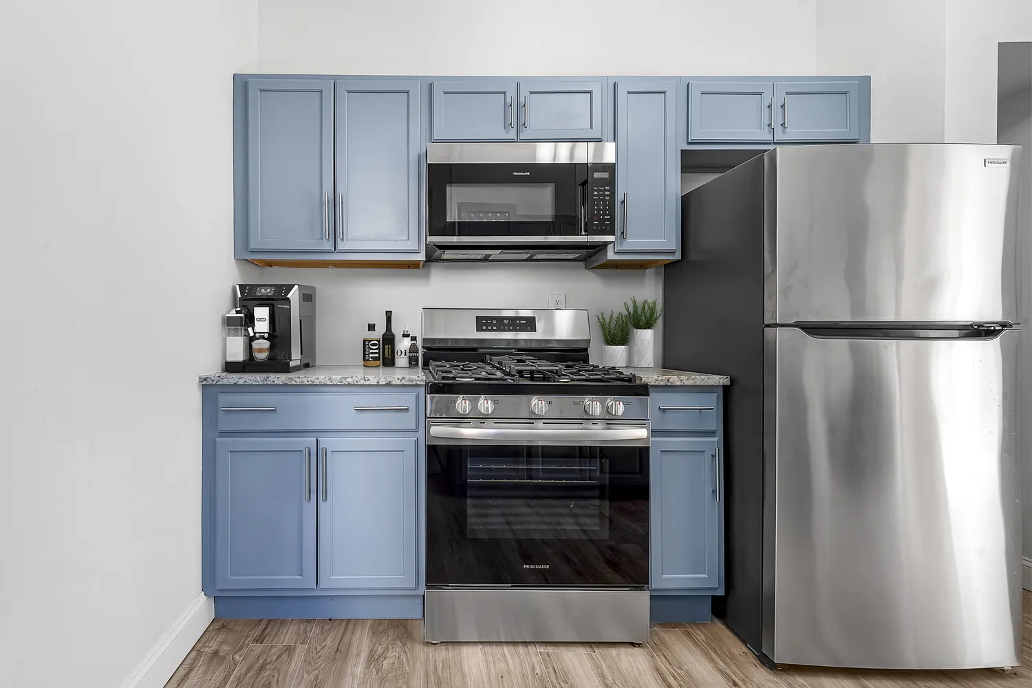 a kitchen with a refrigerator stove and microwave