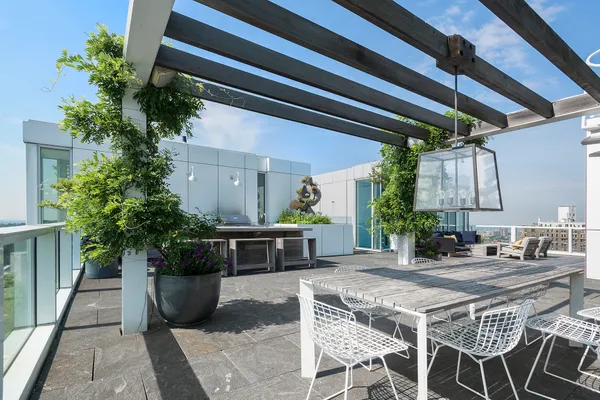a patio with patio couch and potted plants