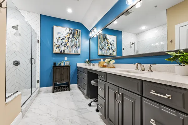 a bathroom with a sink a mirror and a shower