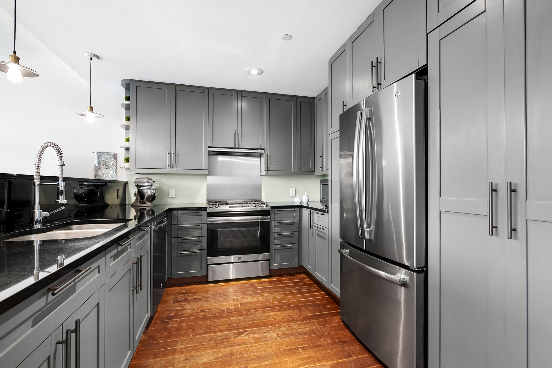32 West 128th Street, Unit 4 Manhattan, NY 10027 - Photo 4 of 11 a kitchen with stainless steel appliances granite countertop a refrigerator and a sink