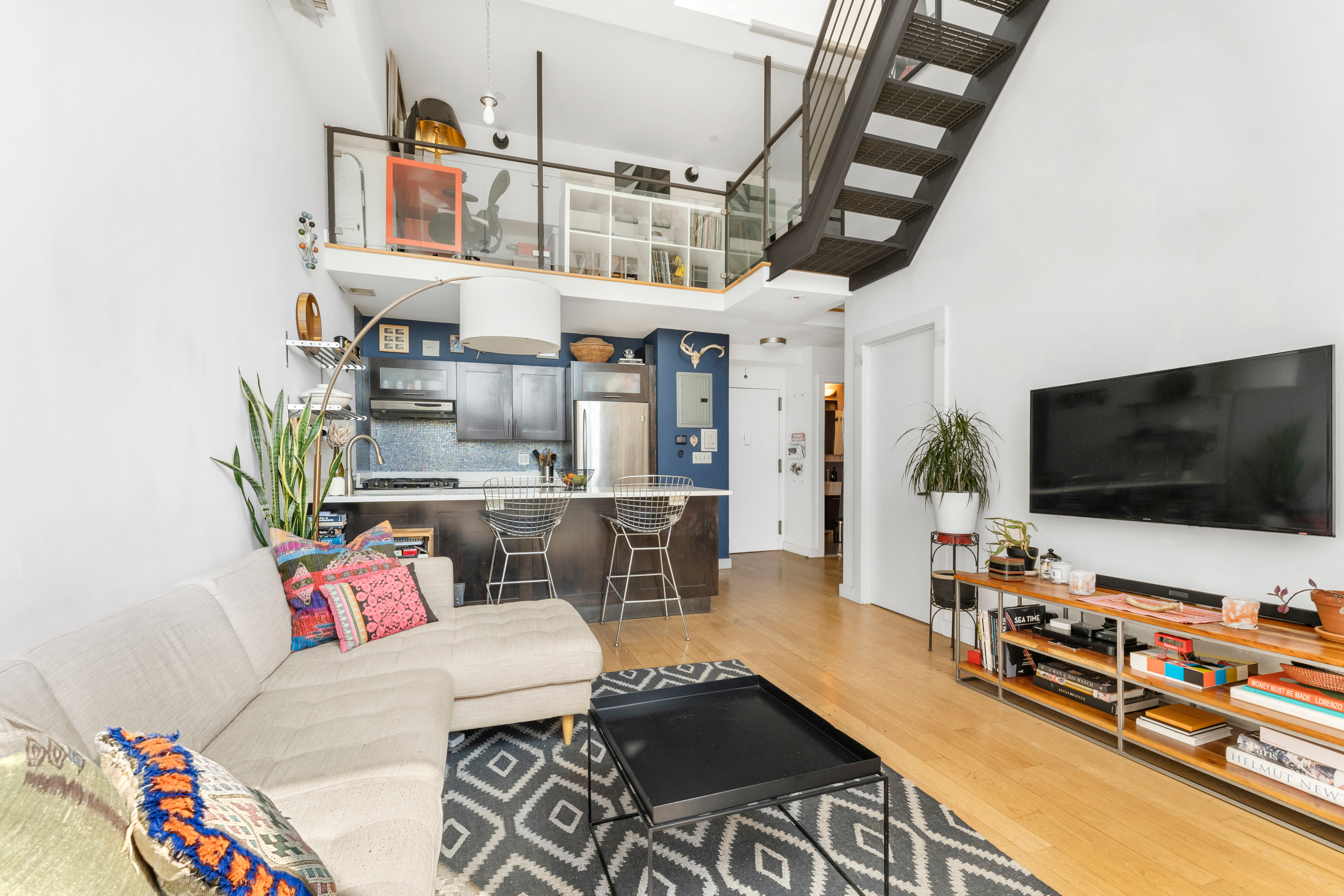151 Manhattan Avenue, Unit 4B Brooklyn, NY 11206 - Photo 4 of 11 a living room with furniture and a flat screen tv