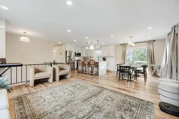 a living room with furniture and a dining table with kitchen view