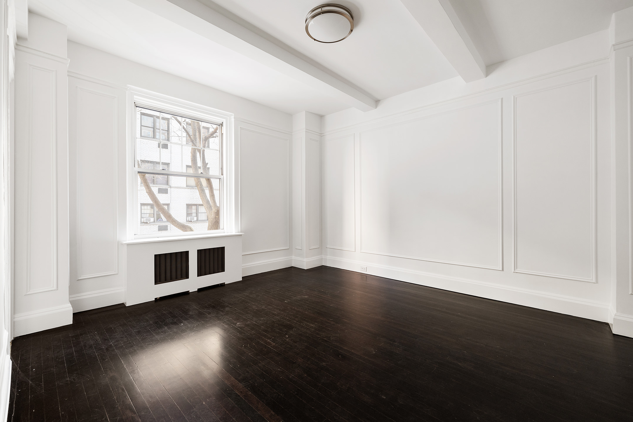 310 West End Avenue, Unit 2A Manhattan, NY 10023 - Photo 10 of 19 an empty room with wooden floor and windows