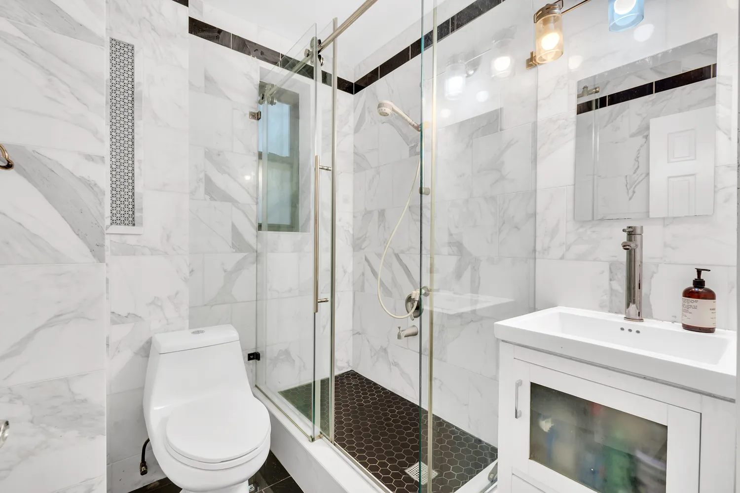 a bathroom with a sink toilet and shower