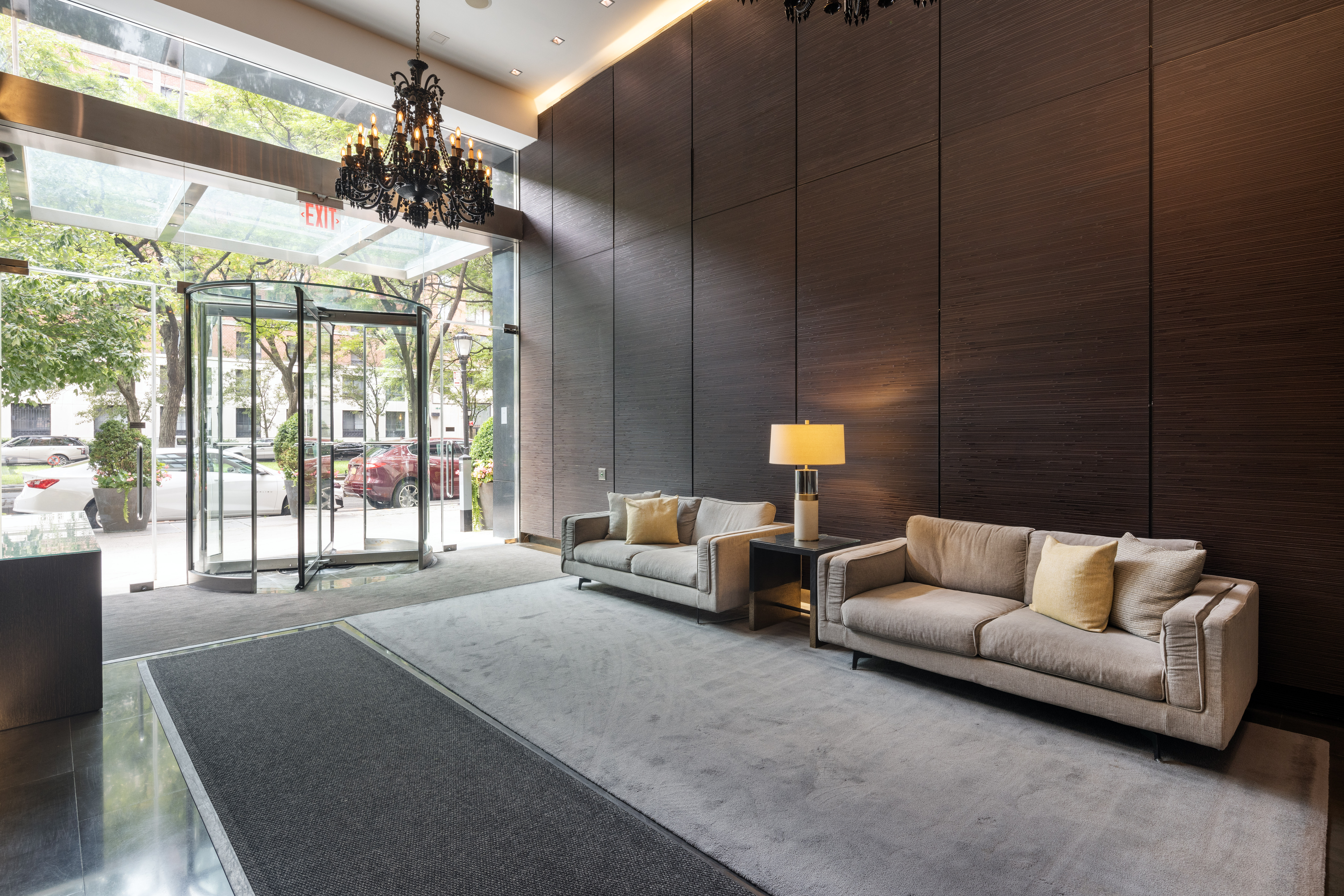 333 Rector Place, Unit 1401 Manhattan, NY 10280 - Photo 7 of 9 a living room with furniture and a chandelier