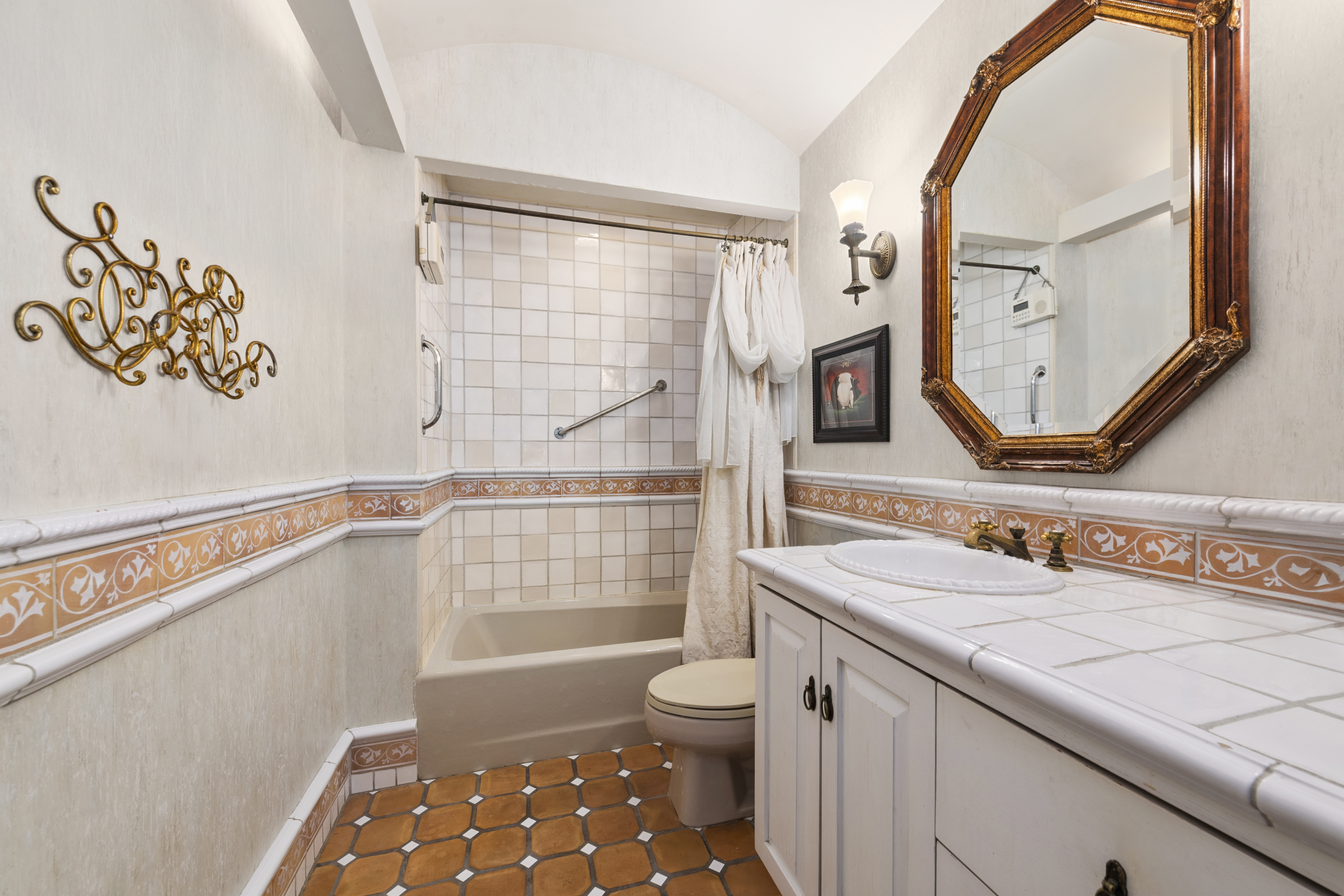 228 West 21st Street, Unit 4 Manhattan, NY 10011 - Photo 8 of 14 a bathroom with a sink a toilet and a mirror