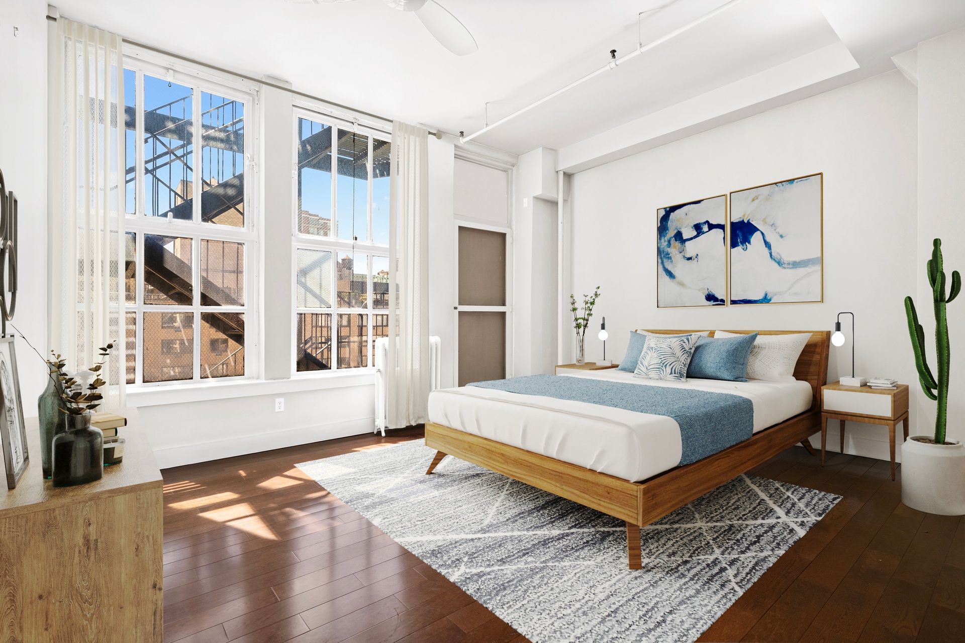 12 West 17th Street, Unit 9 Manhattan, NY 10011 - Photo 8 of 9 a spacious bedroom with a bed and a painting on the wall
