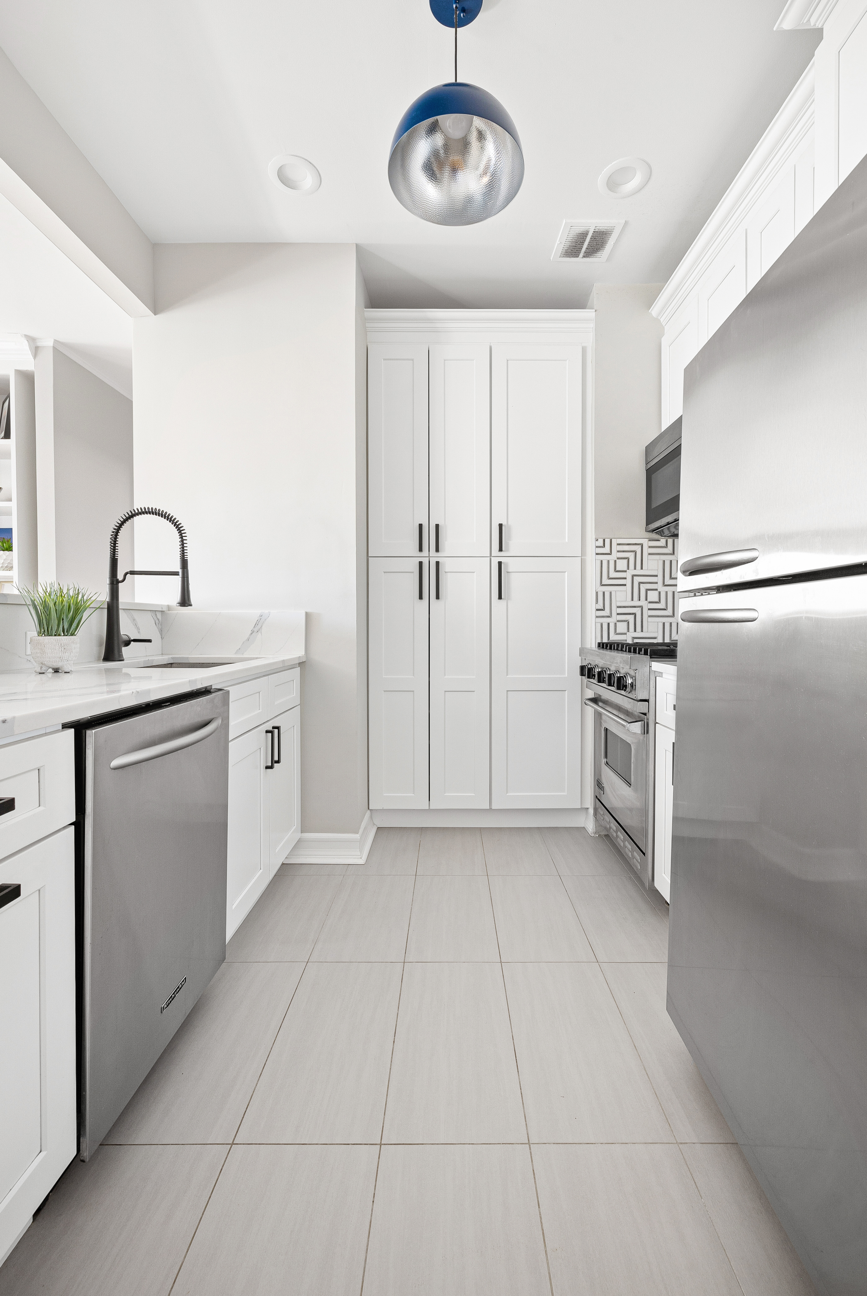 315 West 99th Street, Unit PHA Manhattan, NY 10025 - Photo 6 of 17 a kitchen with a sink cabinets and stainless steel appliances
