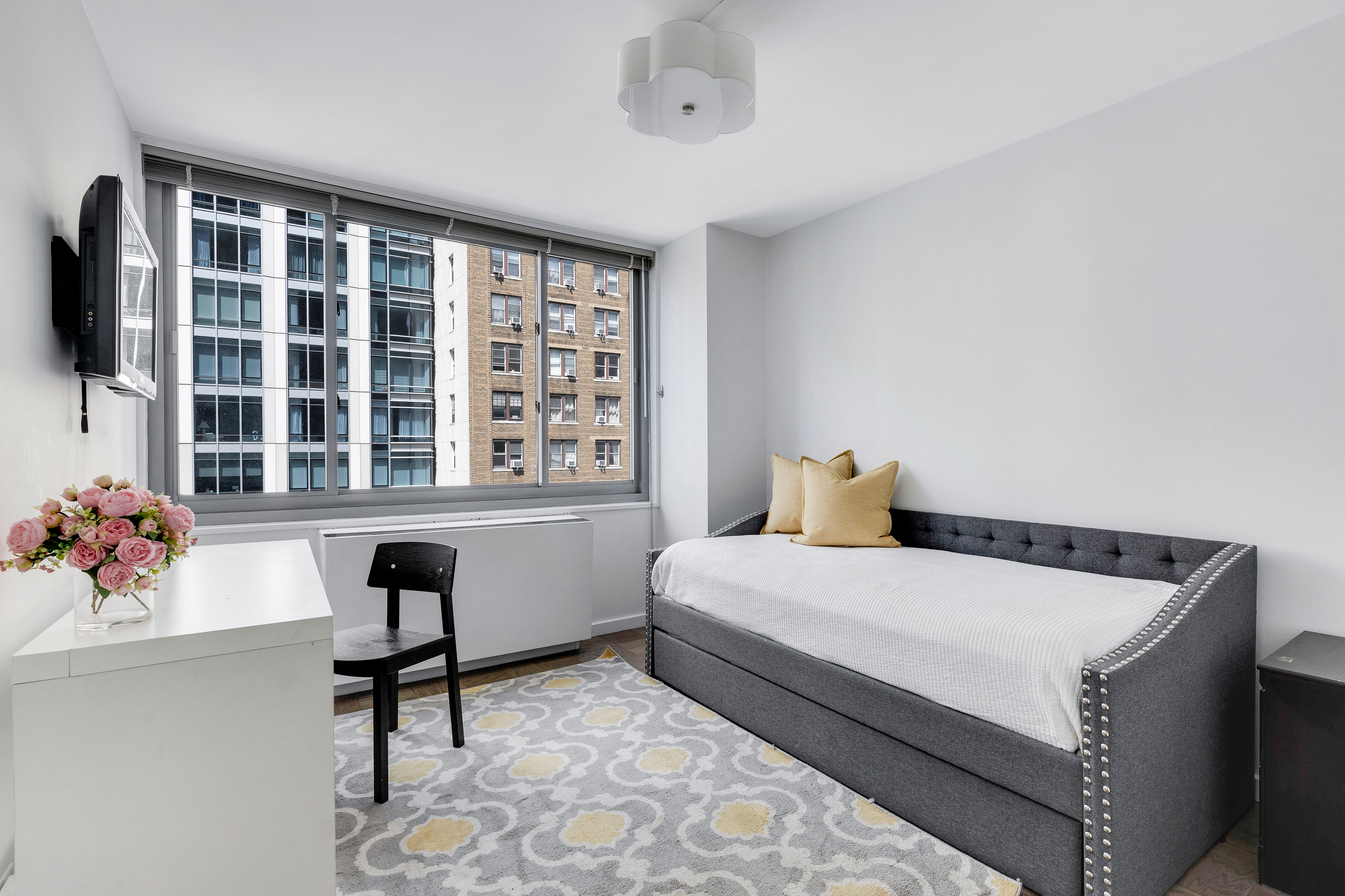 2025 Broadway, Unit 7AB Manhattan, NY 10023 - Photo 8 of 13 a bedroom with a bed and a window