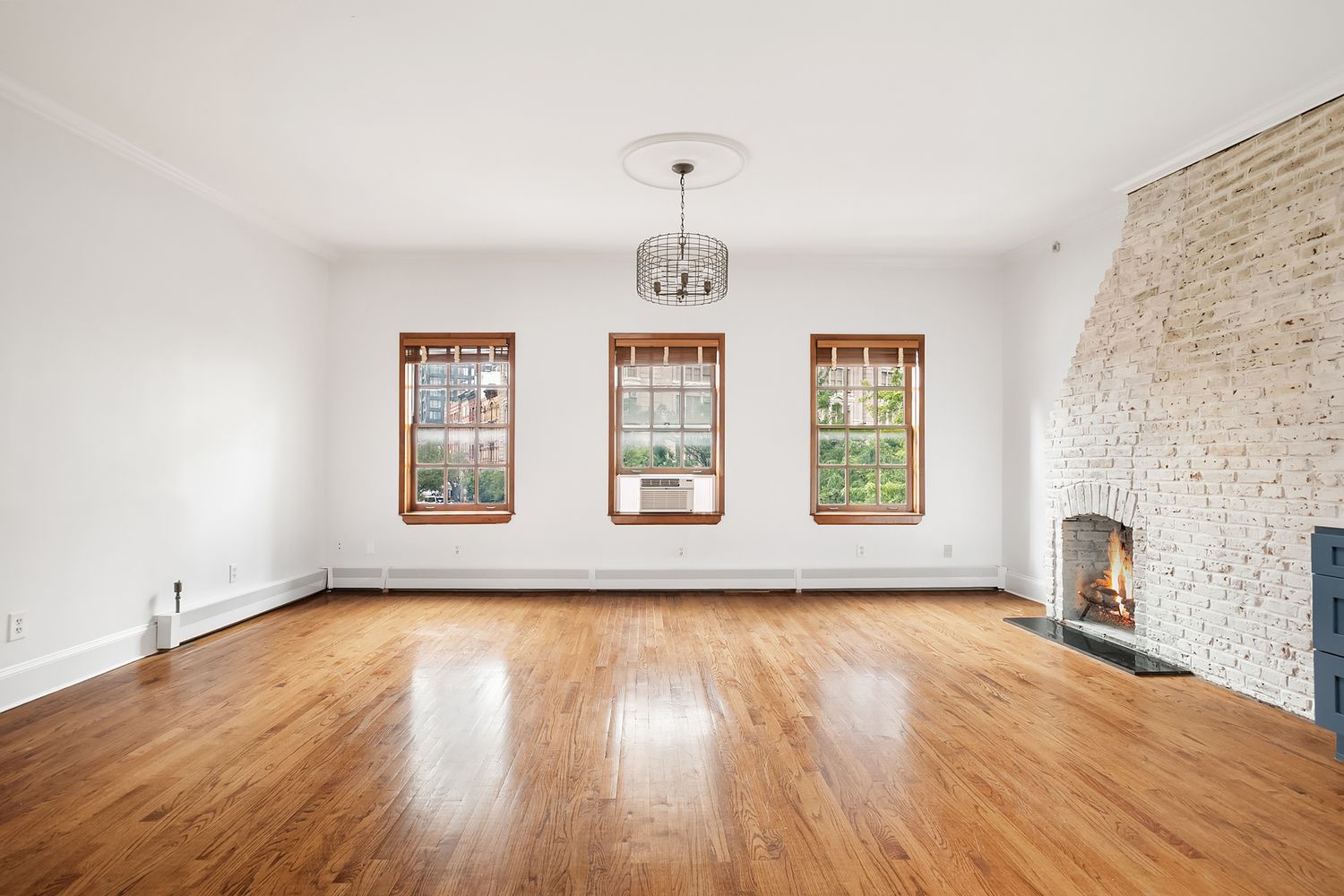 57 Sullivan Street, Unit 4 Manhattan, NY 10012 - Photo 3 of 11 a view of empty room with window and wooden floor