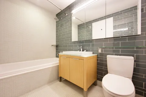 a bathroom with a toilet a sink and bathtub