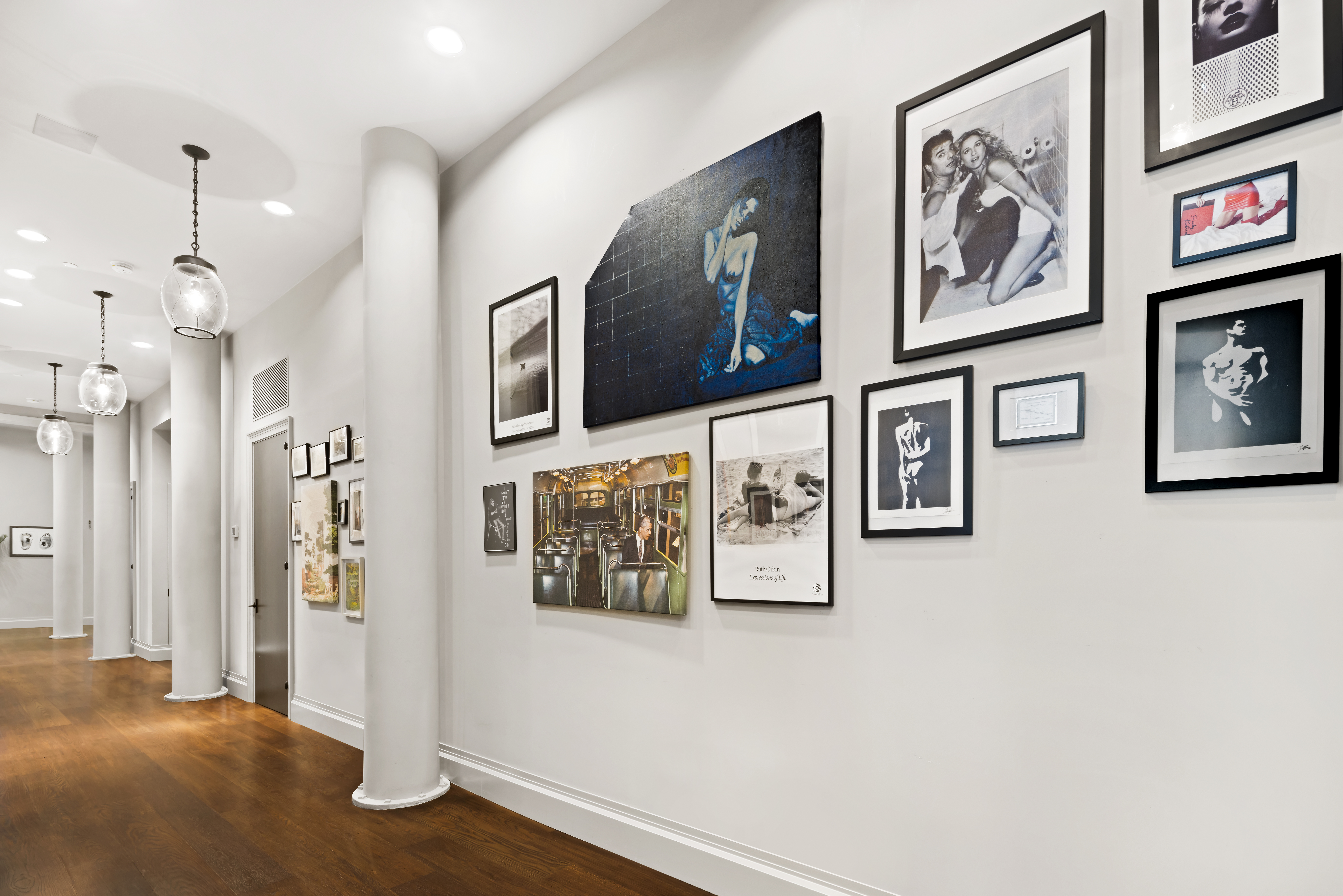 114 Liberty Street, Unit 2A Manhattan, NY 10006 - Photo 8 of 17 a view of a hallway with paintings on the wall